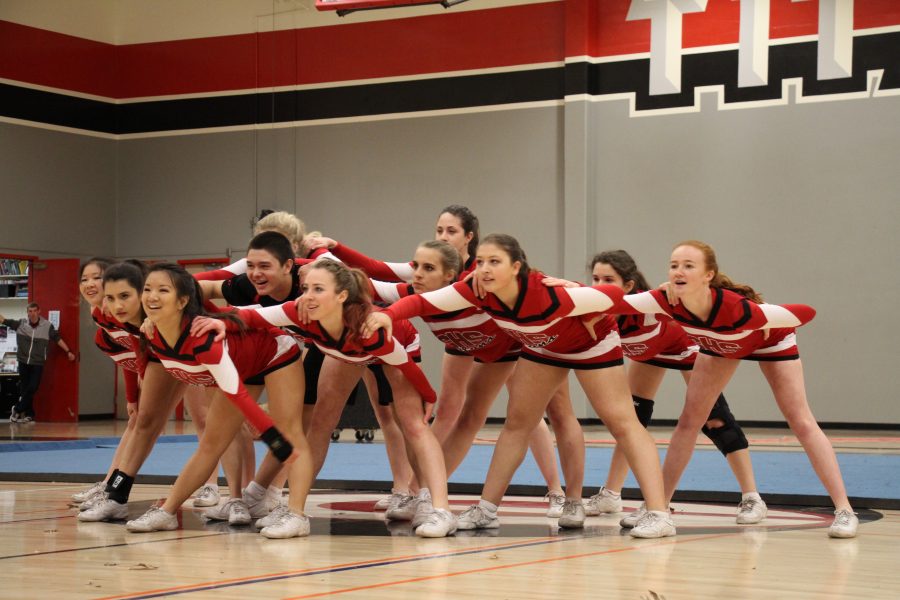Last years cheer team performs its Paly Rally number. This years routine, along with dances routine, will be postponed. Photo by Alexandra Ting