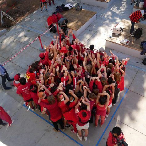 Seniors squeeze close together to fit as many students into the square as possible for Stuff-a-Square, Monday’s brunch game.