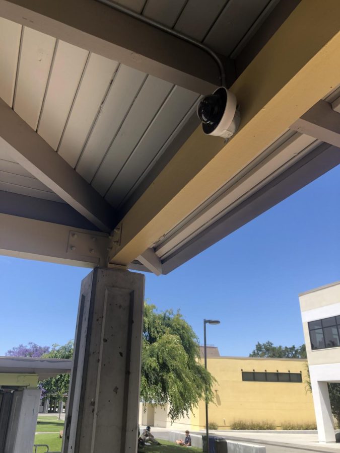 A Cisco Meraki camera mounted on a K-building ceiling. 