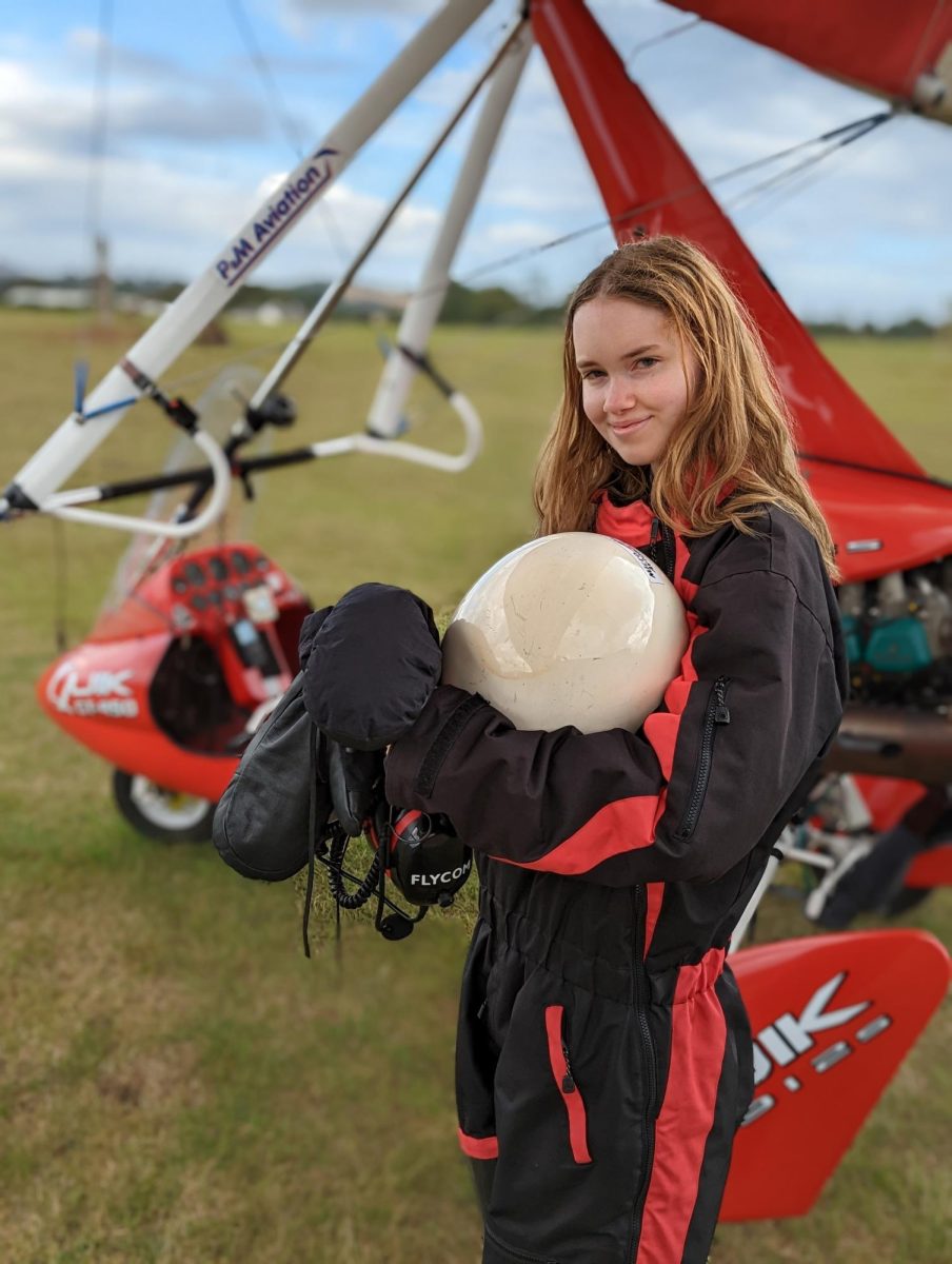 Senior Emma Kochenderfer, suited up, prepares to to fly her plane at the Palo Alto Airport