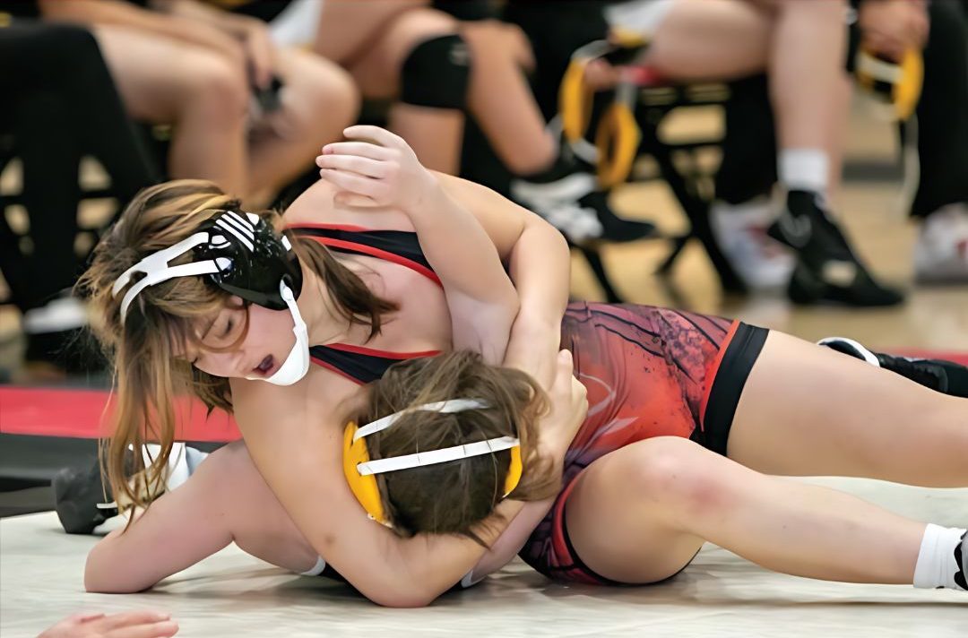 Senior Isabella Lee tackles her opponent during a match for the Gunn wrestling team’s 2023-24 season.