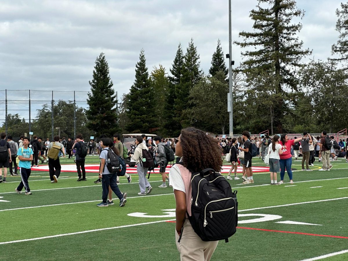 Students begin to leave the football field after the Thursday, August 22 evacuation.